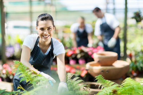 Gardener pruning shrubs in a Battersea garden